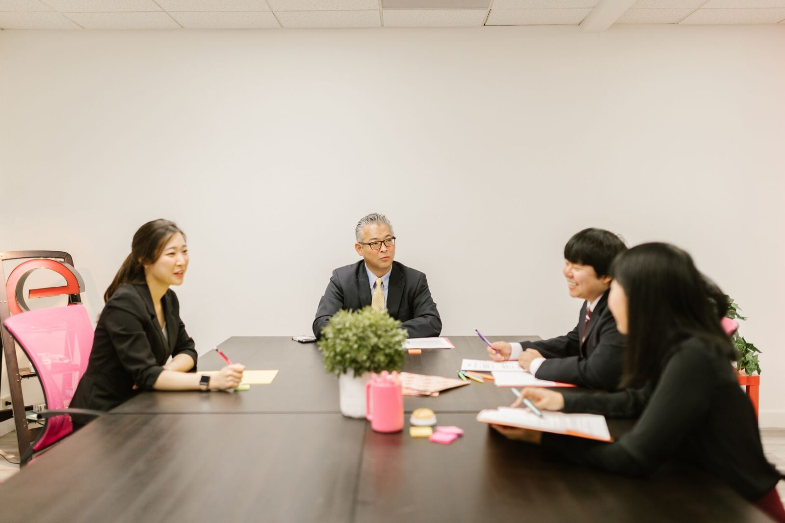 Business professionals having a collaborative meeting around a conference table in a modern office setting.